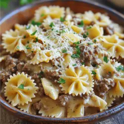 To make a delicious Creamy Beef Bowtie Pasta, gather these ingredients: - 12 oz bowtie pasta - 1 lb ground beef - 1 onion, finely chopped - 2 cloves garlic, minced - 1 cup heavy cream - 1 cup beef broth - 1 cup grated Parmesan cheese - 1 teaspoon Italian seasoning - 1 teaspoon salt - 1/2 teaspoon black pepper - 1 tablespoon olive oil - Fresh parsley, chopped (for garnish) Each ingredient plays a key role in taste and texture. Use precise measurements for best results. Here are some tips: - For the pasta, 12 ounces makes enough for four servings. - Ground beef adds richness; use 1 pound for a hearty dish. - One onion and two cloves of garlic create a strong flavor base. - Heavy cream and beef broth blend well for a creamy sauce. - Use 1 cup of grated Parmesan cheese to finish with a cheesy touch. - Seasonings like Italian seasoning, salt, and black pepper enhance the dish. You can customize this recipe with simple swaps if needed: - Swap bowtie pasta for any pasta shape you like, such as penne or fusilli. - Ground turkey or chicken works well instead of beef for a lighter option. - If you’re dairy-free, try coconut cream or cashew cream instead of heavy cream. - Use vegetable broth instead of beef broth for a vegetarian approach. - Fresh herbs like basil or oregano can replace Italian seasoning for a fresh taste. Feel free to explore variations while keeping the core flavors intact. For the full recipe, check out the recipe section. To start, bring a large pot of salted water to a boil. Add the bowtie pasta and cook it according to the package instructions. You want it to be al dente, which means it should be firm but cooked. This usually takes about 10-12 minutes. Once done, drain the pasta and set it aside. Make sure to not rinse it so it keeps some starch. Next, heat a large skillet over medium heat and add one tablespoon of olive oil. Once the oil is hot, toss in the finely chopped onion and minced garlic. Sauté them for 2-3 minutes until the onion turns soft and clear. This step adds a lot of flavor. Now, raise the heat to medium-high and add the ground beef. Cook it for about 5-7 minutes. Use a spatula to break it up until it’s nicely browned. If there’s extra fat, you can drain it off. Now it’s time to make the sauce. Lower the heat to medium. Pour in one cup of beef broth and one cup of heavy cream. Add one teaspoon of Italian seasoning, one teaspoon of salt, and half a teaspoon of black pepper. Stir this well and let it simmer for about 5 minutes. This will help it thicken and combine all the flavors. Once the sauce is ready, gently add the cooked bowtie pasta into the skillet. Toss everything together to coat the pasta in that creamy goodness. Then, sprinkle in one cup of grated Parmesan cheese and stir until it melts and becomes part of the sauce. This makes the dish rich and tasty. Finally, remove the skillet from heat. Sprinkle some freshly chopped parsley on top for a pop of color and flavor. Serve the creamy beef bowtie pasta warm in shallow bowls. If you want, add more Parmesan and a sprig of parsley for a nice touch. Enjoy your meal! To make perfect bowtie pasta, always use a large pot. Fill it with plenty of salted water. The salt helps give flavor. Bring the water to a rapid boil before adding the pasta. Stir it well to avoid sticking. Cook until it's al dente, which means firm but tender. This usually takes about 10-12 minutes for bowtie pasta. Drain it well, but save a bit of pasta water. You can use this to adjust your sauce later. To boost the taste of your creamy beef bowtie pasta, consider using fresh herbs. Fresh basil or thyme can add brightness. A splash of lemon juice at the end can also lift the dish. If you want some heat, add red pepper flakes while cooking the beef. A sprinkle of extra Parmesan cheese will bring richness too. Don't forget to let your sauce simmer to develop its flavors. Many cooks forget to season the pasta water. This can lead to bland pasta. Also, don’t overcook the pasta, as it will become mushy. Another mistake is adding cheese too early. Wait until the sauce is off the heat to stir in the cheese for a smooth finish. Lastly, be careful with the heat. Cooking too fast can burn the garlic and beef. Follow these tips to avoid common pitfalls and enjoy a tasty meal. For more details on making this dish, check out the Full Recipe. {{image_2}} You can switch out ground beef for other meats. Try ground turkey or chicken for a lighter meal. If you love pork, use ground pork instead. Each option brings a new taste to the dish. For a richer flavor, consider using Italian sausage. Just remember to adjust the seasoning for each meat type. To make this dish vegetarian, skip the meat and try mushrooms instead. You can use 1 pound of chopped mushrooms for great texture. Add extra veggies, like spinach or bell peppers, for a colorful touch. Use vegetable broth in place of beef broth. This will keep the creamy sauce rich but plant-based. Want to kick up the flavor? Add a pinch of red pepper flakes for some heat. A splash of white wine can add depth to the sauce. Fresh herbs, like basil or thyme, can brighten the dish. For a cheesy twist, mix in some ricotta cheese before serving. Try adding sun-dried tomatoes for a burst of flavor. For full details on how to prepare this dish, check the Full Recipe. After you make your creamy beef bowtie pasta, let it cool down. Store any leftovers in an airtight container. Place the container in the fridge. The pasta should last for 3 to 4 days. When you're ready to eat, just check for any off smells or changes in texture. If you want to keep it longer, freezing is a great option. First, let the pasta cool completely. Then, transfer the pasta to a freezer-safe container. You can also use freezer bags. Press out as much air as you can before sealing. It will last for about 2 to 3 months in the freezer. Make sure to label the containers with the date! To reheat, you can use either the microwave or the stovetop. If using the microwave, place the pasta in a bowl. Add a splash of water or broth to keep it moist. Heat in short intervals, stirring in between. If using the stovetop, warm in a skillet over low heat. Stir often to prevent sticking. If the sauce looks too thick, add a bit of cream or broth. Enjoy your meal just like fresh! For the complete recipe, check out the Full Recipe. To add some heat to your creamy beef bowtie pasta, try these ideas: - Add red pepper flakes when cooking the beef. - Stir in diced jalapeños for a fresh kick. - Use spicy Italian sausage instead of ground beef. - Add hot sauce to the creamy sauce for more warmth. These changes will make the dish more exciting without losing its creamy goodness. Yes, you can use gluten-free pasta! Many brands offer gluten-free bowtie pasta. Just cook it according to the package directions. Keep an eye on the cooking time, as it may differ from regular pasta. This way, everyone can enjoy creamy beef bowtie pasta without gluten. You can serve this dish with many tasty sides. Here are some great options: - A fresh green salad with a light vinaigrette. - Garlic bread for a crunchy contrast. - Steamed veggies like broccoli or green beans. - A simple fruit salad for a sweet touch. These sides pair well and complete your meal. For the full recipe, check out the earlier section! This post covered all you need for Creamy Beef Bowtie Pasta. We shared the complete list of ingredients, measurement details, and substitutions. You learned step-by-step how to cook pasta, brown beef, and create the creamy sauce. We also provided tips for best practices and avoiding common mistakes. You can explore variations, including meat options and vegetarian adaptations. Finally, we discussed storage tips for refrigerating and freezing. Use these insights to create a delicious dish every time. Enjoy cooking!