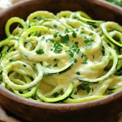 To make a delicious Zucchini Noodle Alfredo, you'll need simple and fresh ingredients. Here’s a list of what you will need: - 3 medium zucchinis, spiralized into noodles - 1 cup raw cashews, soaked for 4 hours and drained - 1 cup unsweetened almond milk - 3 tablespoons nutritional yeast - 2 tablespoons olive oil - 2 cloves garlic, minced - 1 tablespoon lemon juice - Salt and pepper to taste - Fresh parsley, chopped (for garnish) These ingredients work together to create a creamy, tasty dish that feels indulgent but is healthy. The zucchini noodles replace traditional pasta, making this dish light and refreshing. The cashews give a rich, creamy texture to the sauce, while the nutritional yeast adds a cheesy flavor without dairy. It's a win-win! When you gather these ingredients, you'll see how easy it is to bring gourmet flavors to your kitchen. Plus, using fresh zucchinis adds a vibrant touch to your plate. For the full recipe and step-by-step guide, check out the Full Recipe. To start, you need to create zucchini noodles, also known as zoodles. You can spiralize the zucchinis for long, curly noodles. If you don’t have a spiralizer, a vegetable peeler works well too. It will give you thin ribbons. After you prepare the noodles, set them aside on a plate. Next, grab your blender. Combine the soaked cashews, almond milk, nutritional yeast, lemon juice, and a pinch of salt and pepper. Blend until the mixture is smooth and creamy. If the sauce feels too thick, add a bit more almond milk. This will help you achieve the right consistency for your Alfredo sauce. Now it’s time to cook. Heat the olive oil in a large skillet over medium heat. Add the minced garlic and sauté for about one minute until it smells great. Then, add your zucchini noodles to the skillet. Sauté them for 2-3 minutes until they are tender but still a little firm. Pour the creamy cashew sauce over the noodles, tossing to coat all of them evenly. Continue to cook for another 2 minutes, stirring constantly. This way, everything gets heated through nicely. Taste and adjust the salt and pepper if needed. You can find the full recipe [here](#). Cooking zucchini noodles takes skill. Aim for a cooking time of 2-3 minutes. This gives the zoodles a nice crunch. If you cook them too long, they'll become mushy. Remember, you want them tender but still firm. For a creamier sauce, adjust the almond milk. Start with 1 cup, but feel free to add more if needed. This changes the sauce's thickness. Blending cashews well is key. Soak them for 4 hours and drain before blending. This ensures a smooth texture. If it’s too chunky, blend a bit longer. Garnish your Zucchini Noodle Alfredo with fresh herbs like parsley. This adds color and flavor. For a protein boost, pair it with grilled chicken or shrimp. It makes the dish more filling and tasty. Enjoy your meal with these simple tips for a delicious experience! {{image_2}} You can switch almond milk for coconut milk. This change gives a creamy texture and a hint of sweetness. Coconut milk is rich and works well in sauces. You can also try using different nuts for the sauce. Walnuts or macadamia nuts add unique flavors. They blend smoothly and create a rich sauce. Adding spices or herbs boosts the taste. Try basil or oregano for a fresh kick. You can also mix in vegetables like bell peppers or spinach. These add color and extra nutrients. Don’t be afraid to experiment with flavors. It can make your dish more exciting and tasty. For vegan and gluten-free options, this recipe is already a great fit. The key ingredients are plant-based and gluten-free. If you need a nut-free alternative, use sunflower seeds instead of cashews. They can create a similar creamy texture. This makes the dish friendly for those with allergies. To store your Zucchini Noodle Alfredo, first, let it cool down. Use an airtight container to keep it fresh. This dish lasts about 3 to 4 days in the fridge. Always check for any off smells or changes in texture before eating. Yes, you can freeze Zucchini Noodle Alfredo! However, the texture may change when thawed. For best results, freeze the sauce separately from the noodles. When ready to eat, thaw in the fridge overnight. Reheat the sauce on low heat, stirring often. Sauté fresh zucchini noodles while reheating the sauce. This way, you keep the noodles crunchy and the sauce creamy. What are the health benefits of zucchini noodles? Zucchini noodles are low in calories and carbs. They are high in fiber, making them good for digestion. Zucchini also has vitamins A and C, which support your immune system. Plus, they keep you full without heavy calories. Can I make this recipe ahead of time? Yes, you can prepare the sauce ahead. Just store it in the fridge for up to three days. Spiralized zucchini noodles lose crunch when stored. So, make them fresh on the day you serve the dish for the best taste. How can I adjust the recipe for larger servings? To serve more people, simply double the ingredients. Use 6 zucchinis and 2 cups of cashews. Adjust the sauce mixture by blending more almond milk and nutritional yeast for extra creaminess. What is the best way to spiralize zucchini? A spiralizer is the easiest tool for making zucchini noodles. Simply press the zucchini into the spiralizer and turn. If you don’t have one, a vegetable peeler works too. Just slice the zucchini into thin ribbons. Can I substitute cashews in the Alfredo sauce? Yes, you can use other nuts like almonds or sunflower seeds. These will change the flavor slightly but still create a creamy sauce. You can also use silken tofu for a nut-free option that stays creamy. This blog post covers how to make a delicious Zucchini Noodle Alfredo. You learned about the key ingredients, such as zucchini and cashews, along with simple steps to prepare the dish. Tips for texture, alternatives to ingredients, and storage methods were shared too. In conclusion, this dish is tasty, healthy, and versatile. Experiment with flavors to make it your own. Enjoy the cooking process and have fun with it!