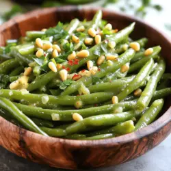 - 1 pound fresh green beans, trimmed - 4 tablespoons unsalted butter Fresh green beans are key for this dish. Choose bright, firm beans for the best taste. Trim the ends to make them ready for cooking. Use unsalted butter to control the salt level in the dish. This butter adds richness and flavor to the beans. - 4 cloves garlic, minced - 1/2 teaspoon red pepper flakes (optional) - Salt and pepper to taste - Juice of 1/2 lemon Garlic is the star in this recipe. It brings a strong, savory flavor. Mince the garlic finely to release its wonderful aroma. Red pepper flakes add a bit of heat, but you can skip them if you prefer a milder taste. Use salt and pepper to enhance the natural flavors of the green beans. A squeeze of lemon juice brightens the dish and balances the richness of the butter. - 1/4 cup toasted pine nuts (for garnish) - Fresh parsley, chopped (for garnish) Garnishes make your dish look great. Toasted pine nuts add crunch and nutty flavor. Chopped parsley gives a fresh pop of color. These extras not only taste good but also make your dish look beautiful and inviting. For the full recipe, check out the Garlic Butter Green Beans 🧄 section. Start by trimming the ends of the green beans. This step helps make them easier to eat. Next, bring a large pot of salted water to a boil. Once boiling, add the green beans and blanch them for about 3 to 4 minutes. You want them bright green and tender-crisp. After that, drain the beans quickly. To stop cooking, transfer them to a bowl of ice water. Let them cool for a few minutes, then drain and set them aside. In a large skillet, melt 4 tablespoons of unsalted butter over medium heat. It melts fast, so keep an eye on it. Next, add 4 cloves of minced garlic to the melted butter. If you like some heat, sprinkle in 1/2 teaspoon of red pepper flakes. Stir frequently for about 1 to 2 minutes. You want the garlic to smell great but not brown. Now it’s time to bring it all together. Add the blanched green beans to the skillet. Toss them well in the garlic butter until they’re coated. Cook for an additional 2 to 3 minutes. This step helps the beans heat through. Finally, squeeze the juice of half a lemon over the green beans. Season with salt and pepper to taste, and toss again. For a lovely finish, transfer the green beans to a serving dish. Top with 1/4 cup of toasted pine nuts and some chopped parsley for flavor and crunch. Enjoy this delicious side dish! For the full recipe, check out the details above. To make the best garlic butter, start with good quality unsalted butter. Melt four tablespoons in a skillet over medium heat. Add minced garlic right after the butter melts. Stir for one to two minutes. You want the garlic to smell great but not brown. If you like a kick, add red pepper flakes. This will make your dish pop! For crisp green beans, blanch them first. Boil a pot of salted water and add your fresh green beans. Cook them for three to four minutes. They should look bright green and feel tender-crisp. Once that’s done, plunge them into ice water. This stops the cooking and keeps them bright and colorful. You can make your garlic butter green beans even better. Squeeze fresh lemon juice on top for a zesty twist. Toasted pine nuts add crunch and richness. Chopped parsley gives a fresh taste and nice color. Feel free to mix in other vegetables like cherry tomatoes or bell peppers. These small changes make a big difference! For the complete recipe, check the Full Recipe section. {{image_2}} You can cook garlic butter green beans in different ways. The stovetop method is quick and easy. Simply blanch the beans, make the garlic butter, and mix. This method keeps them crisp and bright. Oven-roasting gives the beans a different flavor. Preheat your oven to 425°F. Toss the green beans in garlic butter and spread them on a baking sheet. Roast for about 15-20 minutes. This method adds a nice char and depth of flavor. You can make garlic butter green beans even better by adding other veggies. Try sliced carrots or bell peppers for color and crunch. You can also add cherry tomatoes for a burst of sweetness. Just cut them into similar sizes and add them during the cooking process. This way, all your veggies will cook evenly. Nuts and herbs can change the dish's taste. Instead of pine nuts, try walnuts or almonds for a different crunch. You can also experiment with fresh herbs like thyme or rosemary. Add them while making the garlic butter for more aroma. For a fresh twist, mix in some lemon zest or Parmesan cheese at the end. These simple changes can make your garlic butter green beans a unique treat. For the full recipe, check out the Garlic Butter Green Beans recipe details above. After enjoying your garlic butter green beans, you may have some left. Store them in an airtight container. Keep them in the fridge for up to three days. Make sure to let them cool before sealing the container. This helps keep their texture and flavor fresh. To reheat, use a skillet over medium heat. Add a splash of water or a bit of butter to keep them moist. Stir them gently for about 3-5 minutes until heated through. You can also use a microwave. Place them in a microwave-safe dish, cover loosely, and heat for 1-2 minutes. Stir halfway to ensure even heating. If you want to save your garlic butter green beans for later, freezing is a great option. First, cool them completely and pack them in a freezer-safe bag. Squeeze out as much air as possible before sealing. They can last up to three months in the freezer. To use, thaw them overnight in the fridge and reheat as mentioned above. Enjoy this delicious side dish anytime! You can find the full recipe in our earlier sections. Garlic Butter Green Beans last about 3 to 4 days in the fridge. Make sure to store them in an airtight container. This keeps them fresh and tasty. When you want to eat them, just reheat and enjoy! Yes, you can make Garlic Butter Green Beans ahead of time. Just follow the recipe and cool them down. Store them in the fridge until you are ready to serve. Reheat them in a skillet for best results. They will taste nearly as fresh as when you made them. Garlic Butter Green Beans pair well with many dishes. They go great with roasted chicken or grilled fish. You can also serve them with steak or pasta. Adding these green beans to your meal adds color and a burst of flavor. For the full recipe, check out the details above! Garlic butter green beans are simple and tasty. We covered the key ingredients like fresh beans, garlic, and seasonings. I shared easy step-by-step instructions to help you cook them just right. Tips ensure the best flavor and texture every time. You can even explore variations, like adding veggies or trying different cooking methods. Store leftovers safely and reheat them easily for later meals. Now, enjoy making this dish your own! You’re ready to impress with delicious garlic butter green beans.