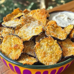 - 1 large eggplant - 2 tablespoons olive oil - 1 teaspoon garlic powder - 1 teaspoon onion powder - 1 teaspoon smoked paprika - 1 teaspoon salt - ½ teaspoon black pepper - 2 tablespoons grated Parmesan cheese - Nutritional yeast for vegan option Gathering the right ingredients is key to making crispy baked eggplant chips. First, choose a large eggplant. Look for one that feels heavy and has smooth, shiny skin. This means it is fresh and full of flavor. Next, olive oil plays a big role in making these chips crispy. It helps the spices stick and adds a nice richness. Garlic powder and onion powder give the chips a savory kick. Smoked paprika adds a warm, smoky taste that enhances the eggplant. Don't forget the salt and black pepper! They balance the flavors and make each bite pop. If you want to take it up a notch, sprinkle some grated Parmesan cheese on top before baking. For a vegan option, nutritional yeast works great too. It gives a cheesy flavor without using dairy. With these ingredients ready, you're set for a tasty snack. For the full recipe, check the detailed instructions. Enjoy crafting your delicious eggplant chips! 1. First, preheat your oven to 400°F (200°C). This helps to make the chips crispy. 2. Next, line two baking sheets with parchment paper. This keeps the chips from sticking. 3. Now, slice the eggplant into thin rounds. Aim for about 1/8 inch thick. A mandoline slicer works best here. This ensures even cooking. 4. Sprinkle salt on both sides of the eggplant slices. This draws out extra moisture. 5. Place the salted slices on a clean kitchen towel. Let them sit for about 30 minutes. After 30 minutes, pat the slices dry with another towel. This step is key for crispiness. 6. In a large bowl, mix the olive oil, garlic powder, onion powder, smoked paprika, salt, and black pepper. This is your seasoning blend. 7. Toss the dried eggplant slices in the bowl. Coat them evenly with the mix for great flavor. 8. Arrange the coated eggplant slices in a single layer on the baking sheets. If you like, sprinkle grated Parmesan or nutritional yeast on top. 9. Bake the slices in the preheated oven for 25-30 minutes. Flip the slices halfway through for even cooking. 10. Keep an eye on them during the last few minutes. You want them golden and crispy but not burnt. 11. Once they are done, remove the chips from the oven and let them cool on a wire rack for a few minutes. This helps them stay crisp. Follow these steps, and you'll have a tasty snack that everyone will love. For the complete list of ingredients and instructions, check the Full Recipe. To make your eggplant chips super crispy, thickness matters. Slice the eggplant into 1/8-inch rounds. Thin slices cook more evenly and get crispier. Use a mandoline slicer for perfect cuts. This tool helps you maintain uniform thickness. A wire rack is key while baking. Placing the eggplant on a rack allows heat to circulate. This prevents steam from making the chips soggy. If you don’t have a wire rack, try using parchment paper. Just flip the chips halfway through baking. This way, both sides get crispy. For the best flavor, use high-quality oils like olive oil or avocado oil. These oils add taste and help with browning. You can also try coconut oil for a unique twist. Get creative with your seasonings! Besides garlic powder and smoked paprika, explore spice blends. Try cayenne pepper for heat or Italian herbs for a savory kick. Nutritional yeast gives a cheesy flavor for vegan options. Mix and match until you find your favorite combo. {{image_2}} You can make crispy baked eggplant chips even more tasty. Try adding spices like cayenne for a kick. Italian herbs, such as oregano or basil, also add nice flavor. For cheese lovers, sprinkle different cheese options on top. You can use Parmesan for a rich taste or nutritional yeast for a vegan twist. Each choice brings something special, letting you create your perfect snack. If you want to switch things up, you can use other veggies. Zucchini makes a great option, too. Slice it thin like eggplant, and follow the same steps. Sweet potatoes can also work well. They add sweetness and a unique flavor. You can mix different veggies for a colorful, crunchy snack. This way, you can enjoy a variety of flavors while keeping it healthy. To keep your crispy baked eggplant chips fresh, use an airtight container. Glass or plastic works well. Store them at room temperature for up to three days. If you live in a humid area, consider keeping them in the fridge. This may help them last longer, but it can make them soggy. For best taste, eat them within two days. When you want to enjoy your leftovers, reheating is key. The best way to keep them crispy is to use the oven. Preheat your oven to 350°F (175°C). Spread the chips out on a baking sheet. Heat them for about 5-10 minutes, checking often. This method keeps them crunchy. Avoid using a microwave, as it can make them soft and soggy. To make eggplant chips crispy, avoid thick slices. Thin slices cook evenly and get crunchy. Another mistake is skipping the salting step. Salting draws out moisture, which helps achieve that crispy texture. After salting, always pat the slices dry using a towel. To enhance the texture, use a wire rack when baking. This allows air to circulate around the chips. Also, use a high oven temperature like 400°F (200°C). This helps them crisp up quickly. Yes, you can use a different oven temperature. If you lower the temperature, extend the cooking time. For instance, at 350°F (175°C), bake for about 35-40 minutes. Always check for doneness as ovens can vary. Eggplant chips taste great with many dips. For homemade options, try tzatziki or hummus. These dips add a creamy texture and fresh taste. For store-bought ideas, salsa or guacamole work well too. You can also go for spicy dips like sriracha mayo for a kick. Try mixing different flavors to complement the chips. Each dip offers a fun twist to your snacking experience. This post covered how to make delicious eggplant chips. We explored the key ingredients, preparation steps, and tips for that perfect crunch. We also discussed storage and reheating so you enjoy them later. Finally, we provided ideas for variations and dips to elevate your snack. Enjoy experimenting with flavors and textures as you create your own version of this tasty treat. Your eggplant chips will impress friends and family alike!