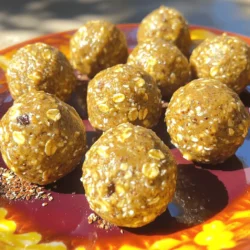 To make Almond Butter Energy Balls, gather these simple ingredients. Each one plays a vital role in flavor and nutrition. - 1 cup almond butter - 1 cup rolled oats - 1/2 cup honey or maple syrup - 1/2 cup ground flaxseed - 1/2 cup dark chocolate chips - 1 teaspoon vanilla extract - A pinch of sea salt Almond butter serves as the base, giving these bites a creamy texture. The rolled oats add heartiness and fiber, while honey or maple syrup provides natural sweetness. Ground flaxseed boosts the nutrition with omega-3 fatty acids. Dark chocolate chips bring a rich flavor, perfect for satisfying your sweet tooth. You can swap honey for maple syrup, depending on your taste. The vanilla extract enhances the overall flavor, making every bite delightful. Finally, a pinch of sea salt balances the sweetness, making these energy balls truly irresistible. For the full recipe, follow the steps to create these tasty snacks that energize you throughout the day! 1. Mixing the Ingredients Start by grabbing a large mixing bowl. Add 1 cup of almond butter, 1 cup of rolled oats, and 1/2 cup of honey or maple syrup. Then, toss in 1/2 cup of ground flaxseed, 1/2 cup of dark chocolate chips, 1 teaspoon of vanilla extract, and a pinch of sea salt. Mix everything well. You want a sticky dough that holds together. 2. Forming the Balls Next, it’s time to roll your mixture into balls. Take a small amount of dough and shape it into a ball about 1 inch wide. If your hands get too sticky, lightly wet them with water. This makes rolling easier. Place each ball on a baking sheet lined with parchment paper. 3. Refrigeration Process Once you finish rolling all the balls, put the baking sheet in the fridge. Let them chill for about 30 minutes. This helps the energy balls firm up. After they are set, move them to an airtight container. They can stay in the fridge for up to a week or you can freeze them for later. - How to Present For a fun presentation, arrange the energy balls on a bright plate. You can sprinkle some extra ground flaxseed on top for a nice touch. This makes them look even more inviting. - Pairing Ideas Enjoy these energy balls with a side of fresh fruit or yogurt. They also pair well with a cup of tea or coffee. This makes for a balanced snack or quick breakfast. Try them as a post-workout boost too! For the full recipe, check out the detailed instructions above. One common mistake is overmixing. If you mix too much, the dough can become tough. You want a sticky mix that holds together but is still soft. On the other hand, under-mixing can lead to uneven flavors. Make sure all ingredients are blended well but don’t overdo it! Another mistake is incorrect ball sizing. If your energy balls are too big, they won’t set properly. Aim for about 1 inch in diameter. This size is just right for a quick snack. Smaller balls are easier to grab and eat on the go. To enhance flavor, try adding spices or extracts. Cinnamon or nutmeg can add warmth to your energy balls. A splash of almond or coconut extract can also give them a nice twist. Experiment with what you like! Using different mix-ins can change the texture and taste. Chopped nuts, dried fruit, or seeds are great options. You can also swap dark chocolate chips for white chocolate or dried cranberries for a fruity punch. Creativity is key! {{image_2}} You can still enjoy energy balls if you have nut allergies. Sunflower seed butter is a great choice. It has a similar texture and flavor. You can use it in place of almond butter. This swap keeps your energy balls creamy and tasty. You might want to change some other ingredients too. For example, you can use pumpkin seeds instead of flaxseed. They offer a nice crunch and add healthy fats. You can also skip the chocolate chips if you want. Instead, try dried fruit for a sweet twist. If you follow a vegan diet, you can easily make these energy balls vegan. Just use maple syrup instead of honey. This keeps the recipe plant-based and just as yummy. For gluten-free options, choose certified gluten-free oats. This ensures that your energy balls are safe for those with gluten sensitivities. You can also add gluten-free protein powder for an extra boost. It helps keep you full longer and adds more nutrients to your snack. Check out the Full Recipe for more details! To keep your Almond Butter Energy Balls fresh, store them in the fridge. Place them in an airtight container. This helps prevent moisture and keeps them tasty. They will last about a week this way. If you notice they start to dry out, try adding a little more almond butter next time. For longer storage, you can freeze the energy balls. Place them on a baking sheet first. Freeze them for about an hour until they are firm. Then, transfer them to a freezer-safe bag or container. This keeps them fresh for up to three months. When you're ready to eat one, just take it out and let it thaw at room temperature. You can also pop it in the microwave for a few seconds. Enjoy them anytime you want a healthy snack boost! For the full recipe, check out the details above. Almond Butter Energy Balls last about one week in the fridge. They keep well when you store them in an airtight container. At room temperature, they stay fresh for about three days. If you want them to last longer, refrigerate them right after making. For the best taste, enjoy them fresh! Yes, you can make Almond Butter Energy Balls ahead of time. They are great for meal prep. Just follow the full recipe and store them in the fridge. You can make a big batch and keep them ready for snacks throughout the week. This way, you always have a healthy treat on hand! You can get creative with Almond Butter Energy Balls! Some popular swaps include: - Nut-free: Use sunflower seed butter instead of almond butter. - Sweeteners: Try agave syrup or brown rice syrup. - Mix-ins: Add dried fruit, like cranberries or apricots. - Seeds: Substitute chia seeds for flaxseed for a different texture. Feel free to experiment and find your favorite mix! In this blog post, I shared a simple recipe for Almond Butter Energy Balls. You learned about the key ingredients, including almond butter, oats, and dark chocolate chips. I walked you through mixing, forming, and refrigerating the balls, with tips to avoid common mistakes. You can even explore nut-free and vegan options. For storage, I provided ways to keep them fresh short-term and long-term. These energy balls are a tasty and healthy snack. Enjoy making them!